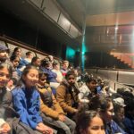 Year 5 children at theatre seeing a play.