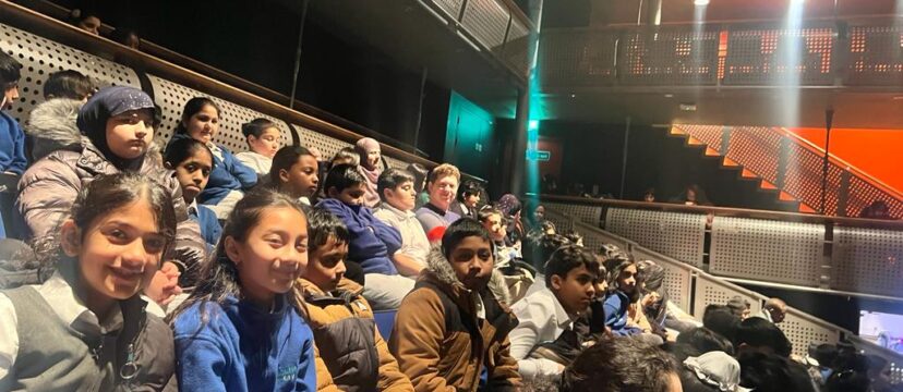 Year 5 children at theatre seeing a play.